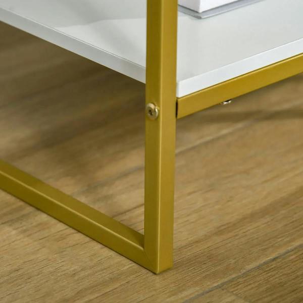 Gold metal leg and support bar of a white bedside table with drawer and open shelf.