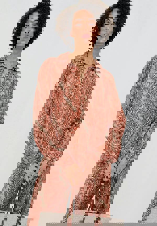 Woman wearing a patterned outfit on a white background