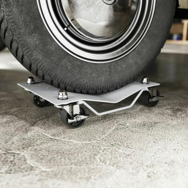 Swivel caster wheel dolly with non-slip metal plate supporting a car tire.
