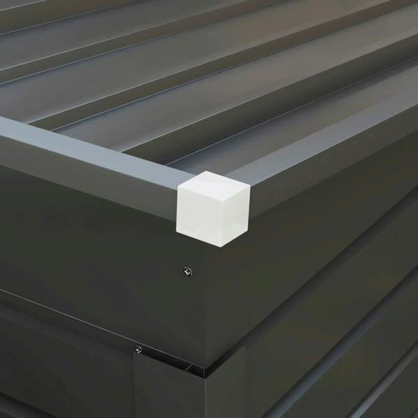 Grey metal shed corner gutter and downspout outlet under the roof edge