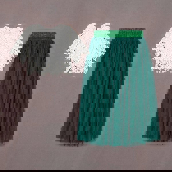 White lace top and green tulle skirt on a gray background