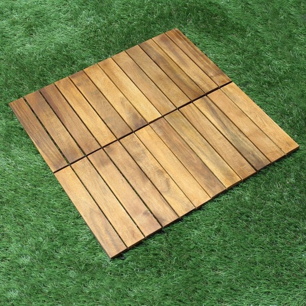 Natural wood decking tiles arranged in a square pattern, showcasing rich brown tones and smooth texture on green grass background