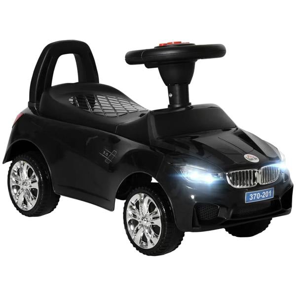 Black ride-on car toy for toddlers with front wheels, steering wheel, and foot pedal