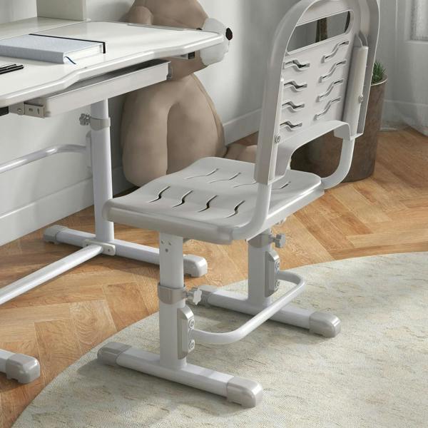 Grey height-adjustable kids chair next to adjustable study tabletop