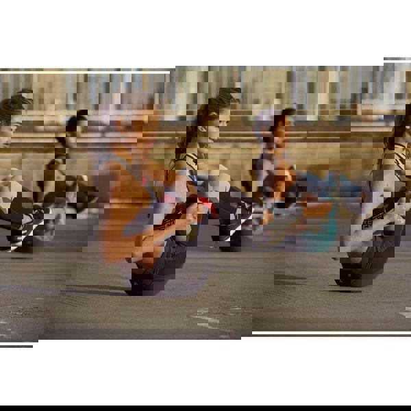 Two women doing a kettlebell workout using Reebok 4kg Cast Iron Kettlebells