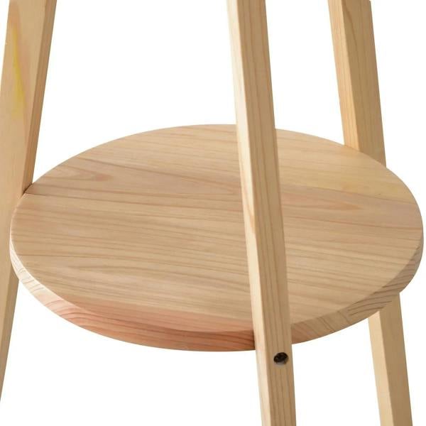 Round natural wood shelf on a tripod floor lamp stand, showing wood grain