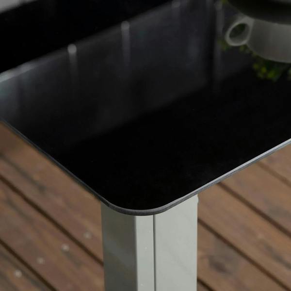Tempered glass tabletop corner with black surface and gray aluminum table frame
