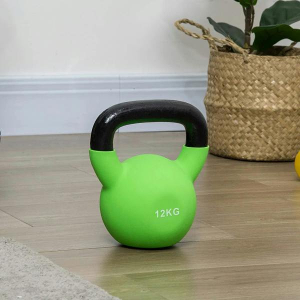 Green 12kg soft kettlebell standing on the floor with black handle