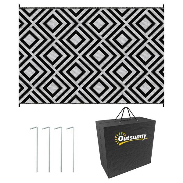 Black and white reversible outdoor rug with geometric diamond pattern and stitched border