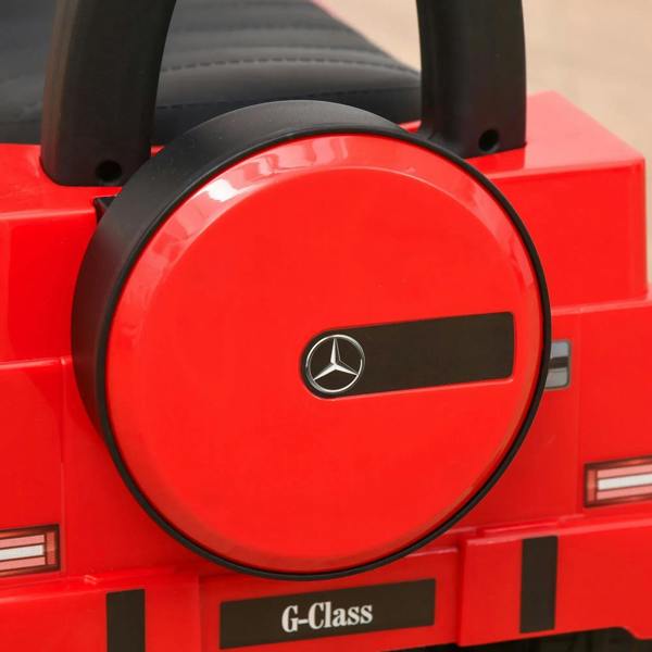 Red kids ride-on car dashboard with black steering wheel and G-Class badge