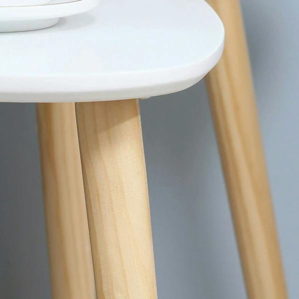 Bottom view detail of white tabletop edge and solid wood support legs