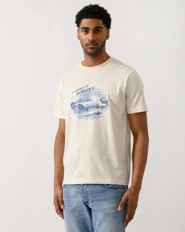 model wearing a GANT Mens Graphic Short Sleeve T-Shirt in 130 Cream