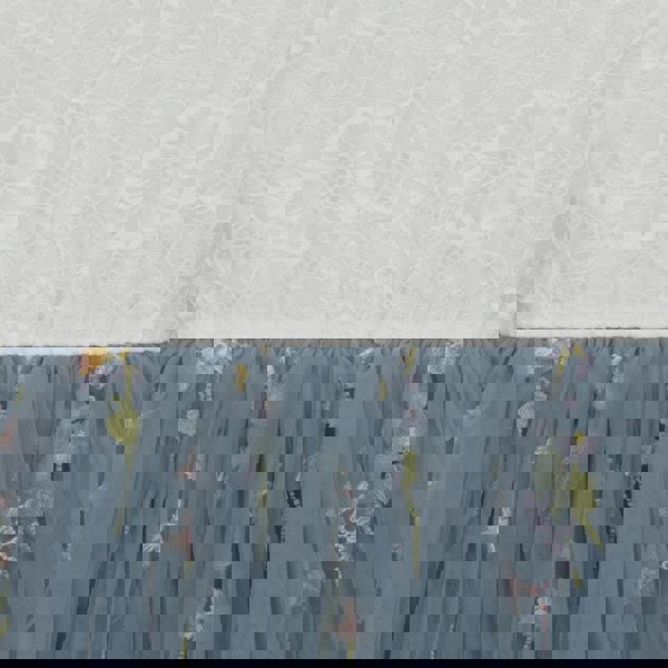 Blue embroidered skirt with floral patterns on a textured white background