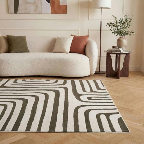 Living room with a patterned rug, sofa, and side table.
