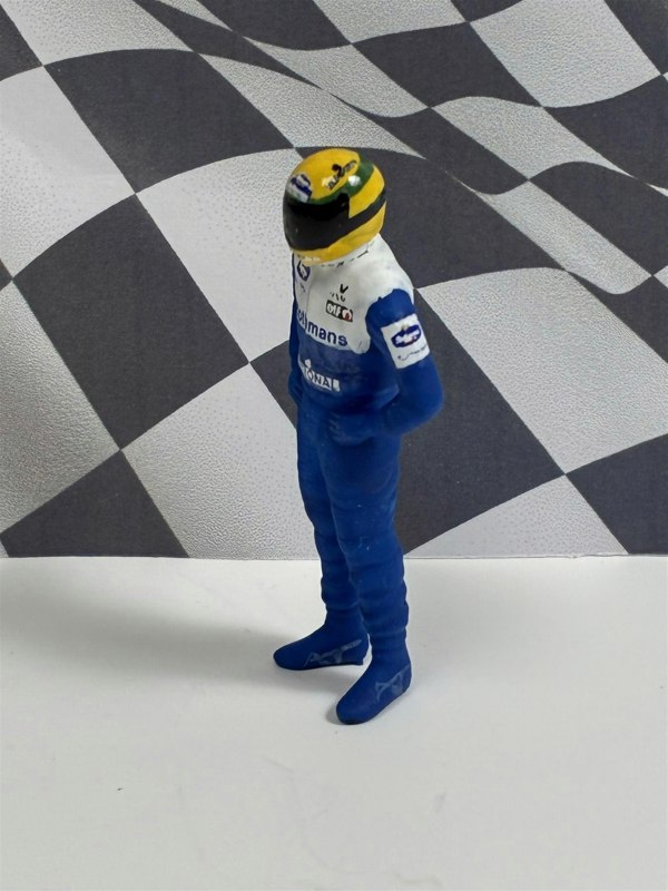 a toy figure of a race car driver