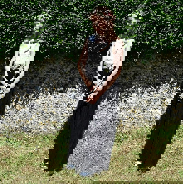 Young girl wearing flower dress and holding wand