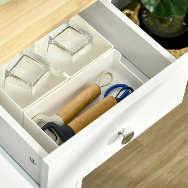 White sideboard drawer interior with dividers; cookware tools and glassware stored inside