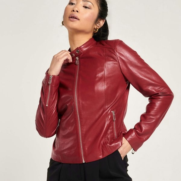 Image shows a woman wearing a red leather jacket which is fully zipped.