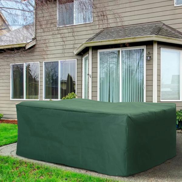Green patio furniture cover over rectangular sofa table set on front lawn