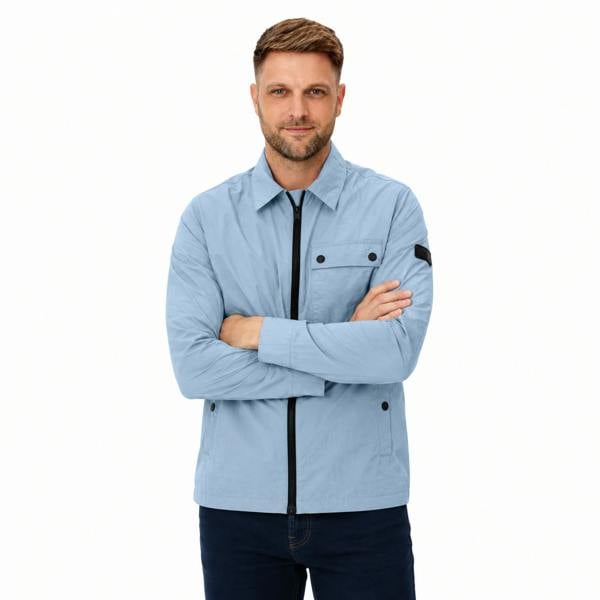 Man wearing a powder blue Barbour International zip-up overshirt with a chest pocket and black trim details.