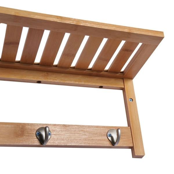 Close-up of wall-mounted wooden coat rack top shelf and 4 metal hooks.