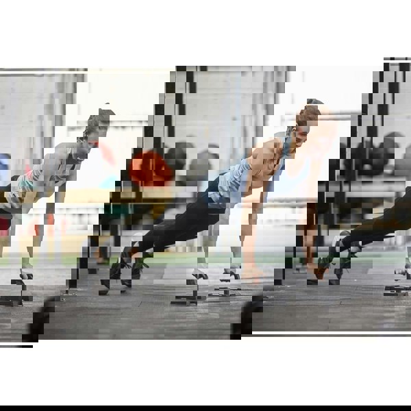 Woman performing push-ups in a gym setting