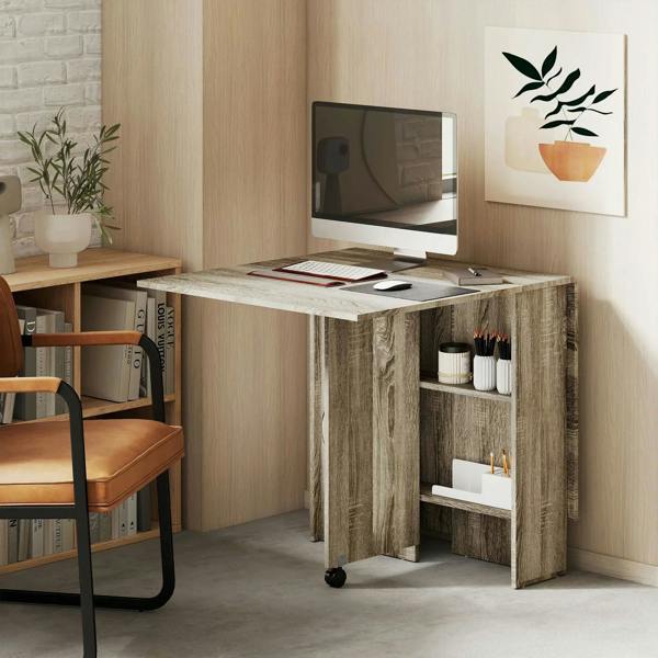 Grey folding dining table with open shelves and rolling casters beside TV