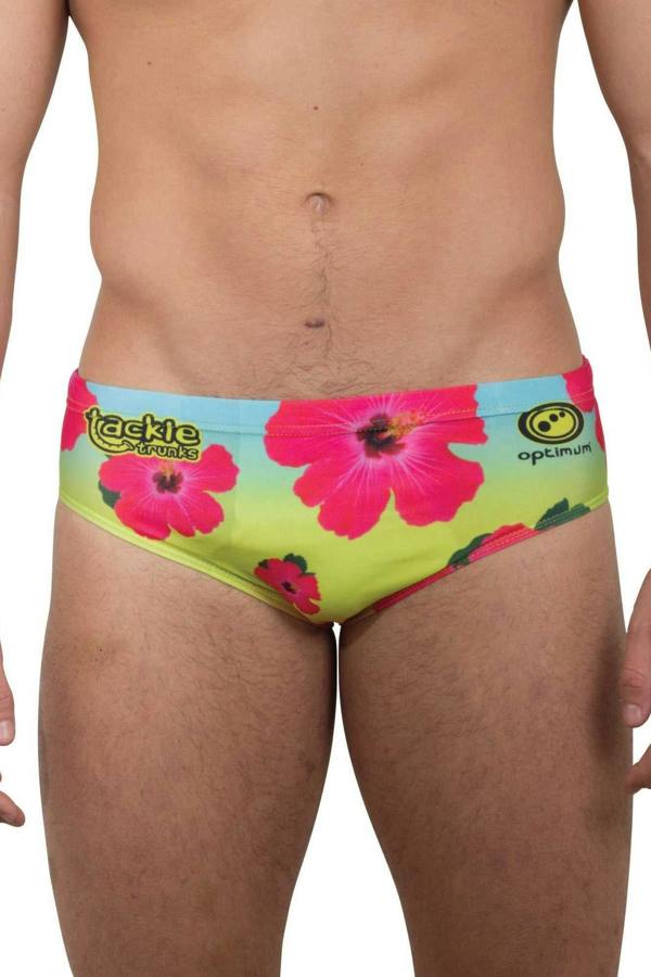 Optimum Tackle Trunks swim brief in neon hibiscus floral print, front view on male model with tackle trunks logo - Optimum
