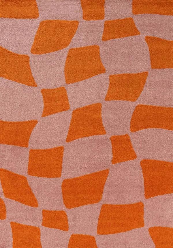 Patterned fabric with orange geometric shapes on a pink background
