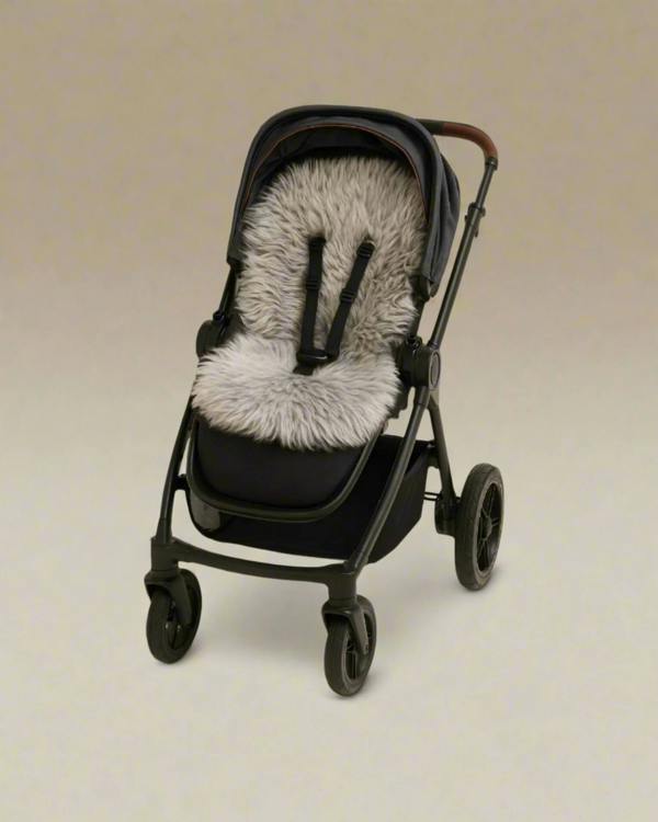 Black stroller with a gray sheepskin pram liner