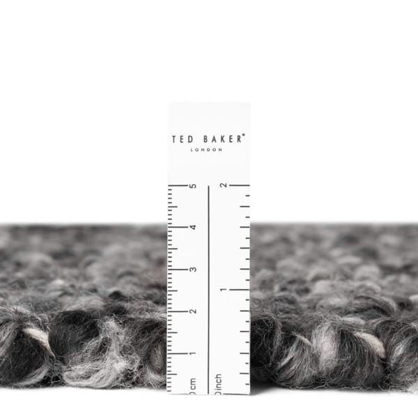 Gray textured fabric with a ruler and 'Ted Baker London' label on a white background