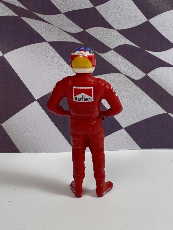 a toy figure of a man wearing a red uniform