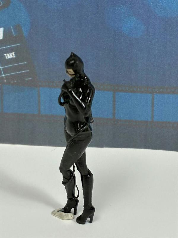 a toy figure of a woman wearing a black cat suit