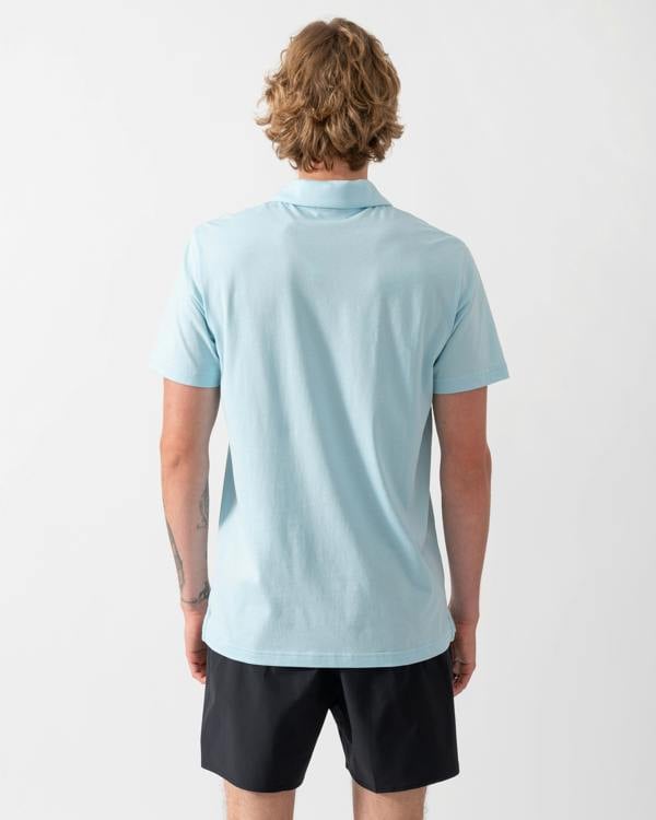 back of a model wearing an Emporio Armani Mens Beach Polo with Eagle Logo in Sky blue
