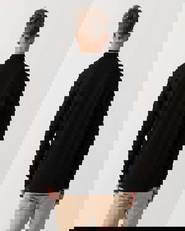 Model wearing HUGO Dinote Mens Long Sleeve Polo Shirt in Black 001 - Back