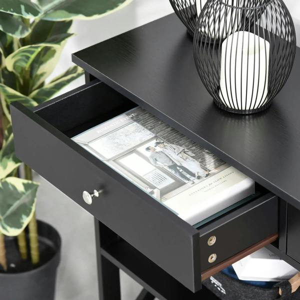 Black console table drawer open with storage inside, round knobs, and X-frame shelving