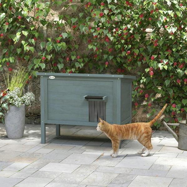 Charcoal gray wooden feral cat house on legs with front entrance and side access