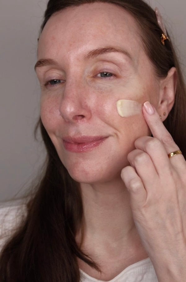 Lady with dark hair with Anara Radiance Moisturiser on her face
