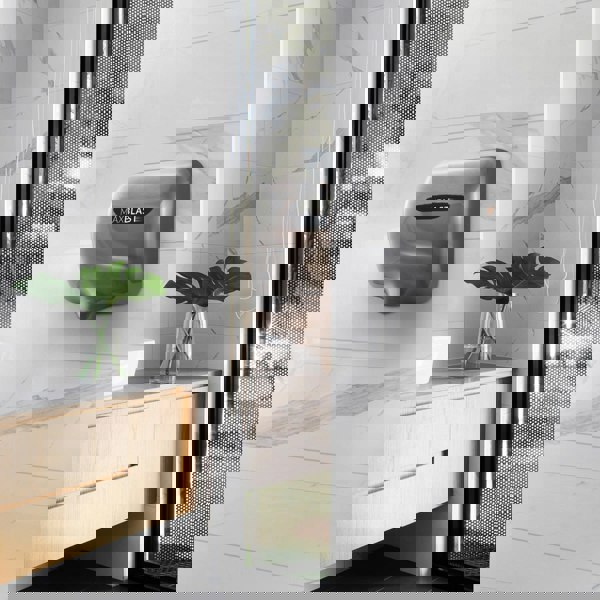 Maxblast automatic commercial hand dryer in sleek silver finish with HEPA filter, mounted on a modern bathroom wall with marble tiles