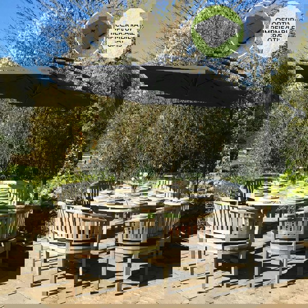 Black cantilever parasol with a square base, featuring a sleek design, providing shade over a round dining table set in a garden