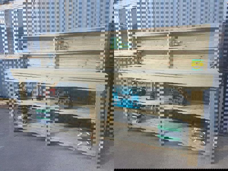 Indoor/Outdoor Pressure-Treated Double Shelf with back panel Workbench, a robust and versatile solution for all your workspace needs. Handcrafted in the UK, this workbench is constructed from high-quality, pressure-treated timber, ensuring durability and resistance to the elements, making it suitable for both indoor and outdoor use.