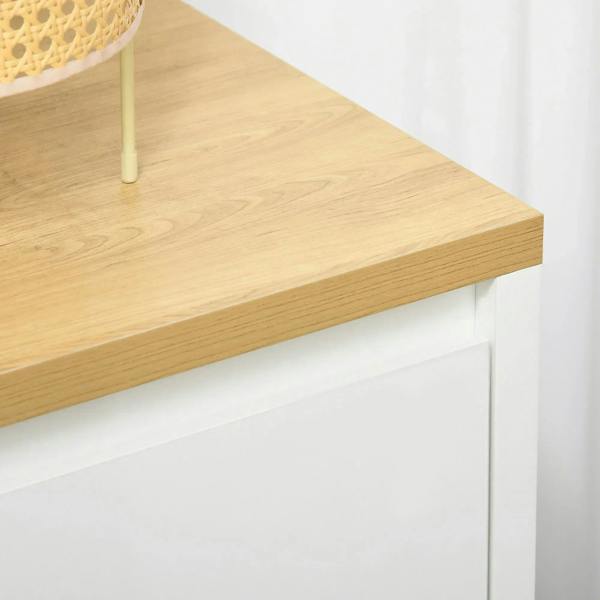 Light wood tabletop corner on a white double-door storage cabinet