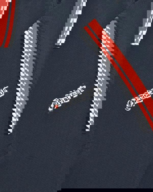 Lambretta Contrast Tipped Mens Mod Ska Casual Polo, close-up of navy blue polo shirt with red and white striped accents on collar and sleeve, featuring Lambretta logo embroidery.