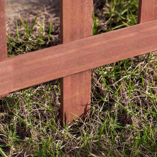 Rustic brown wooden fence rail joint with vertical stake and visible wood texture