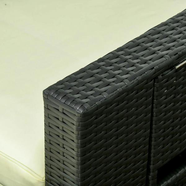 Close-up of black woven wicker armrest with cream cushion on outdoor lounger