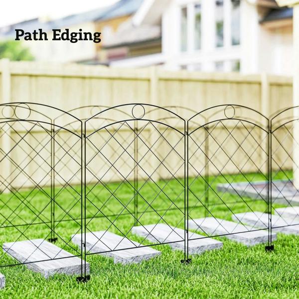 Black steel outdoor fence panels outlining a walkway edge with diamond grid and stakes.