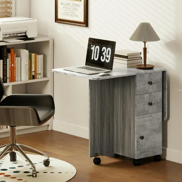 Grey drop-leaf dining table with marble-effect top, three drawers, and caster wheels