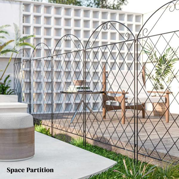 Black metal diamond-mesh fence panels with arched tops as a patio space divider