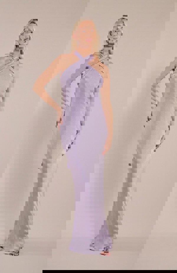 Model wearing halterneck satin bridesmaids dress in a shade of pastel lilac.