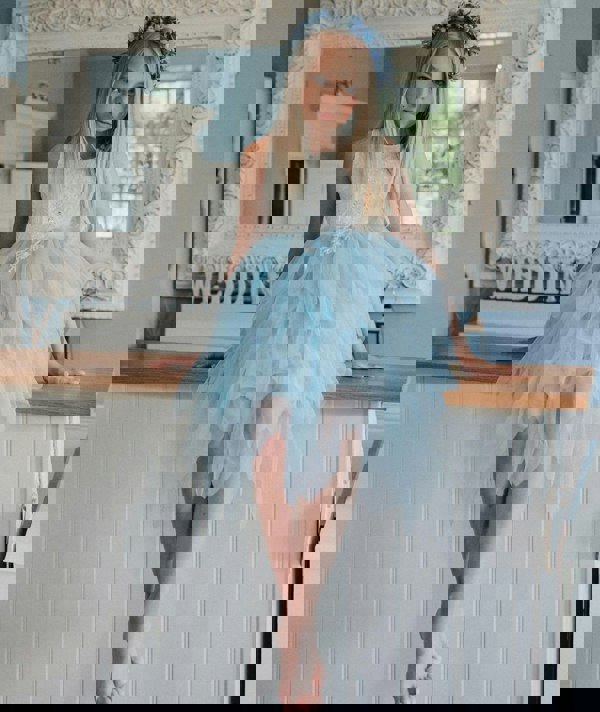 pretty flower girl sitting on side